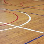 Wooden floor of sports hall with marking lines